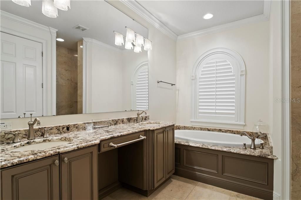 Owner's retreat  bathroom with double vanity and jacuzzi tub, marble shower.