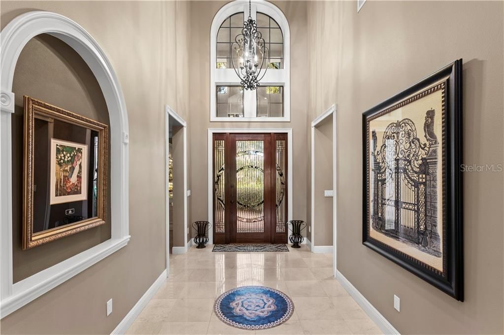 Entryway of home showcasing $5000K custom made leaded glass door and sidelights...