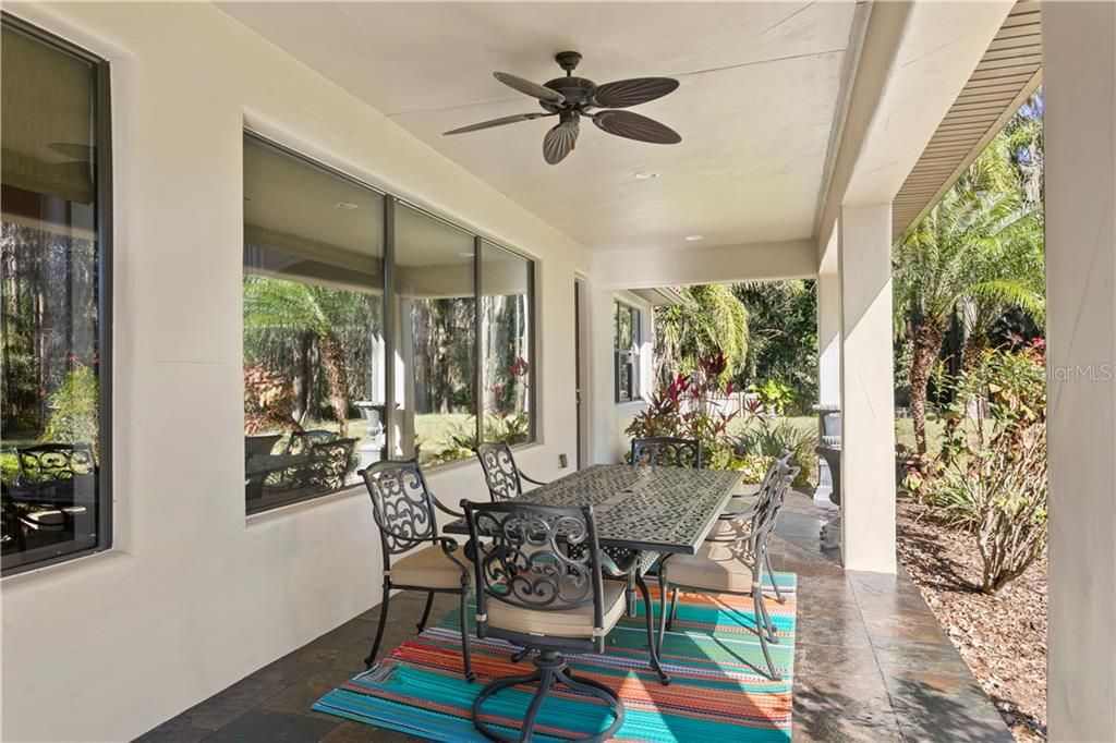 Covered lanai is perfect for entertaining and has an outdoor rated high speed fan that will literally keep any flying insects away! Outdoor half bath entry is off this lanai.