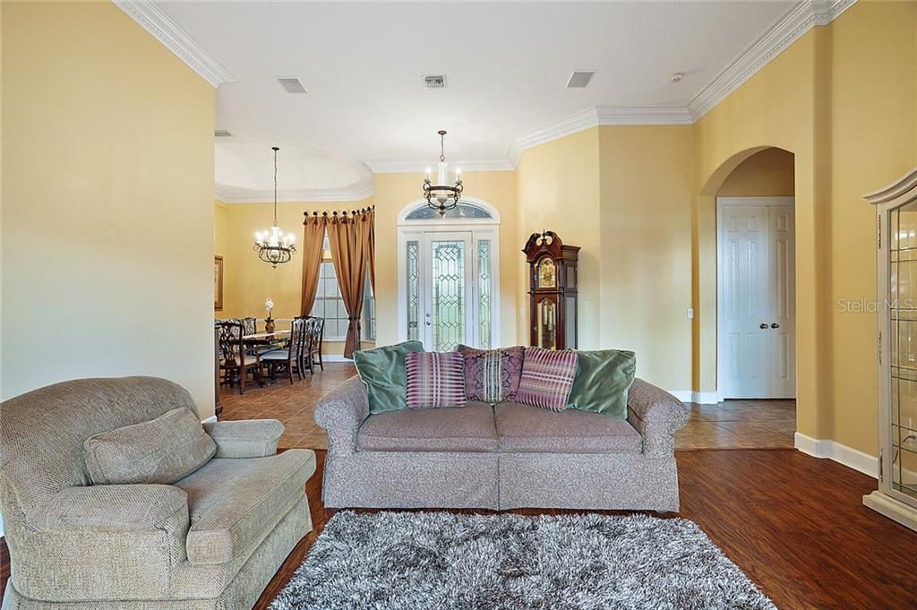 Formal Living Room with Laminate Flooring and Crown Molding