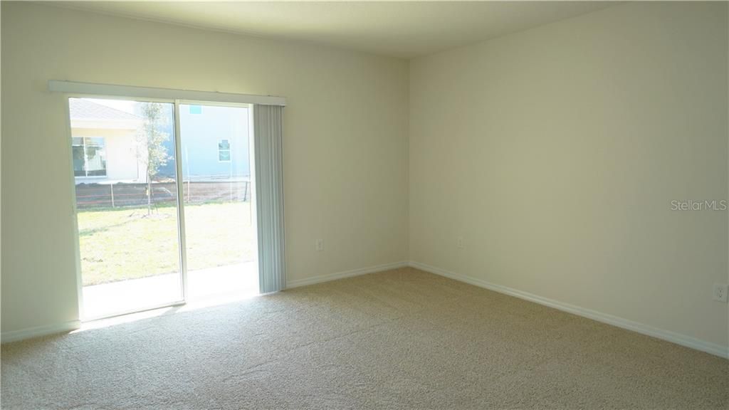 Living Room with Sliding Glass Door to the  Covered Patio