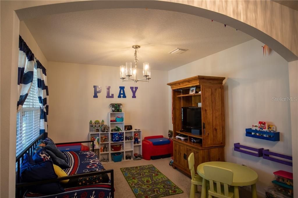 Downstairs Flex space Here being used as a play room but could be a home office, dining room or what ever you the new homeowner would like to do with it.