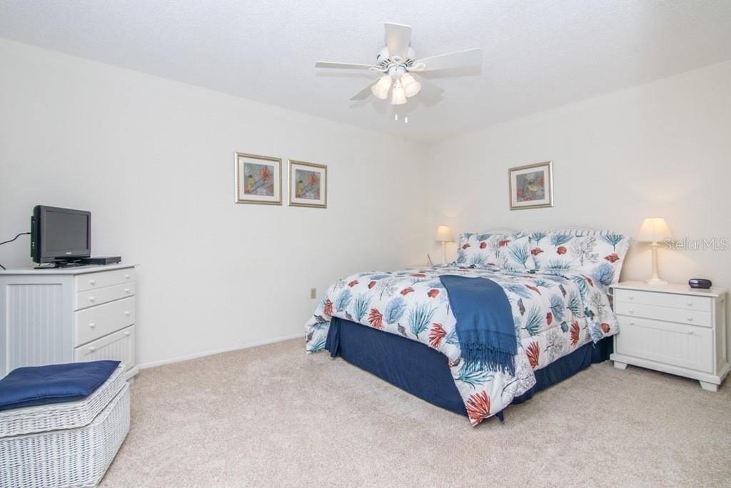 2nd bedroom is spacious and includes a sliding door looking out to front patio.