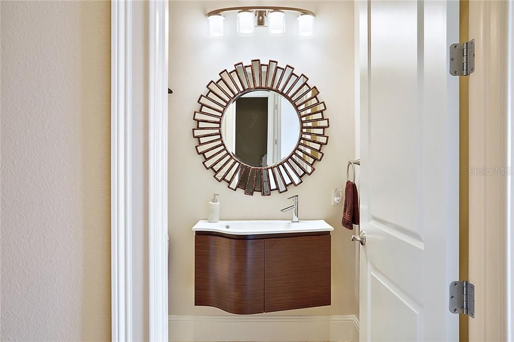 Half-bath with artistic floating vanity, accessible to lanai ~