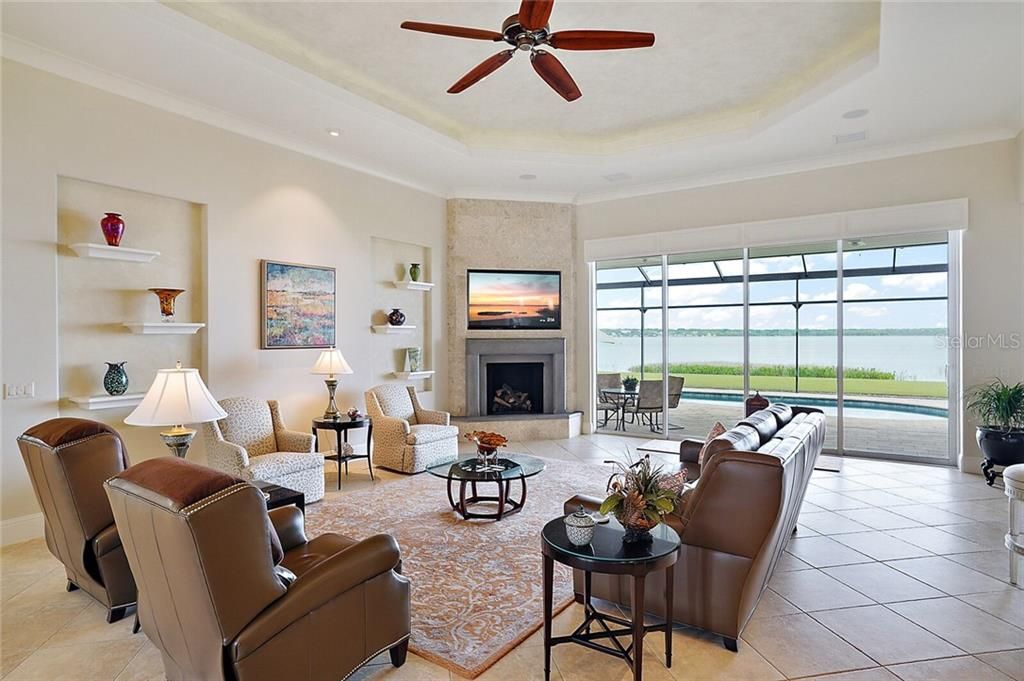 Living room with gas fireplace, uplighting in ceiling, amazing lake views ~