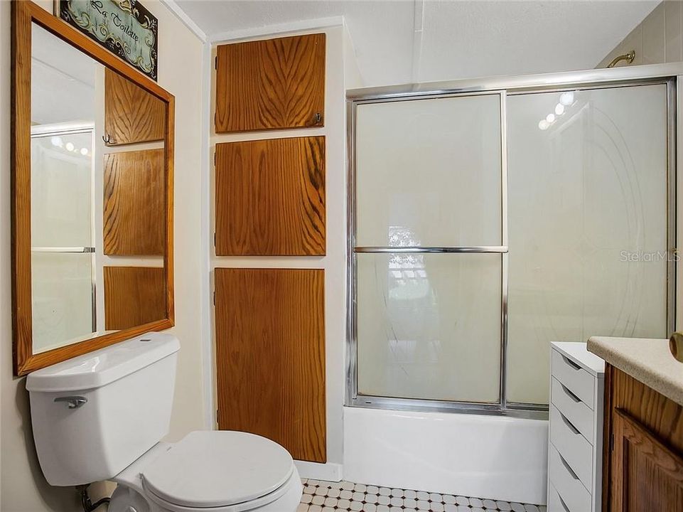The roomy bathroom offers a shower/tub combo.