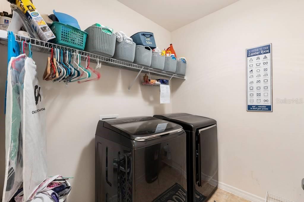 Large Laundry with washer dryer and storage