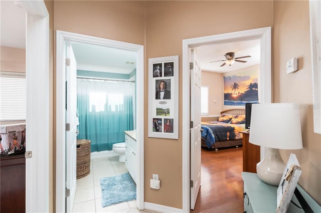 hall way with two bedrooms that share the center bath