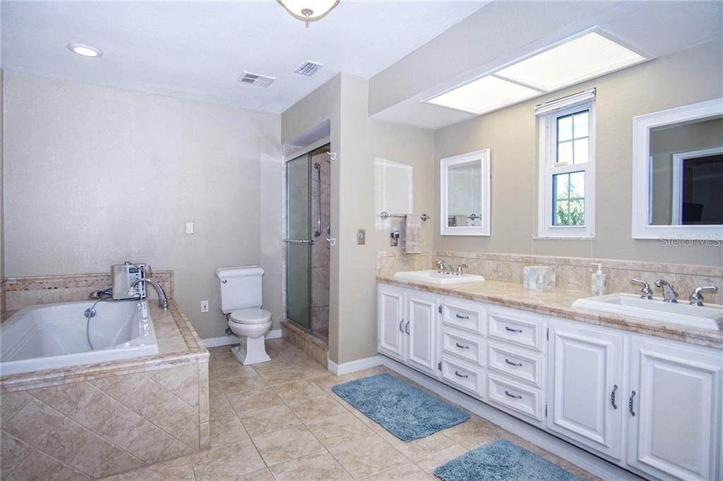 Master bath offers double vanity with storage, deep tub and separate shower.