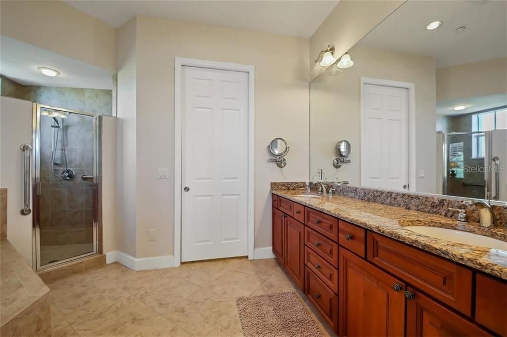 Mater bathroom with double sinks, generous size shower and soaking tub