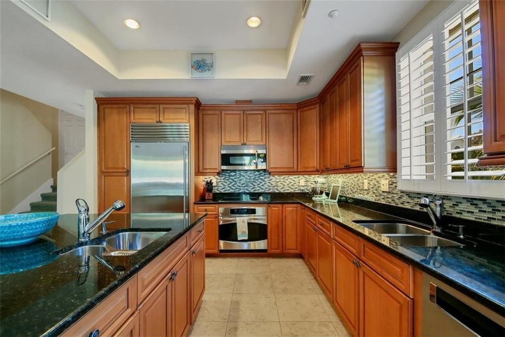 Kitchen showing off amazing tray ceiling to beautiful granite counter with nice natural light