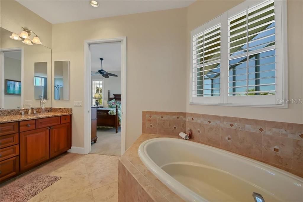 master bathroom showing off the beautiful soaking tub and more natural light