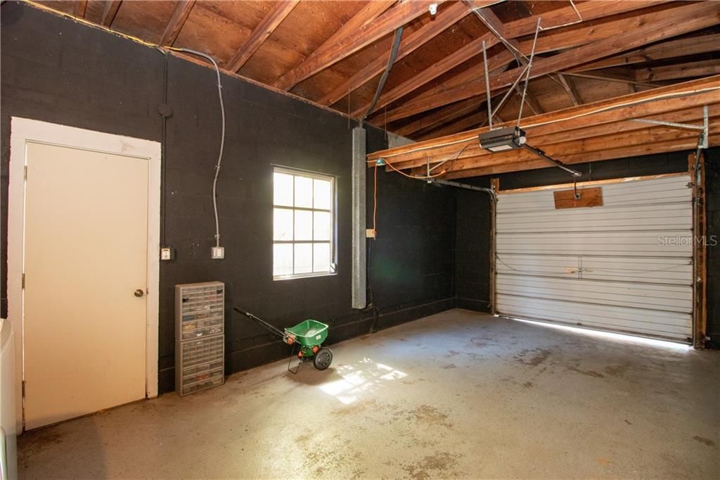 One car, attached garage.  Enter from the alley.  Doors lead to the backyard and house.