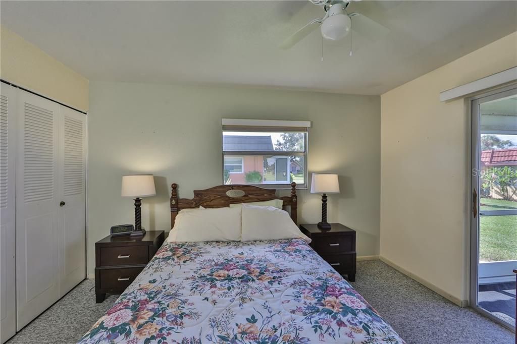 Second bedroom is spacious with a huge wall to wall closet for lots of storage.  Sliding glass doors lead onto screened lanai.