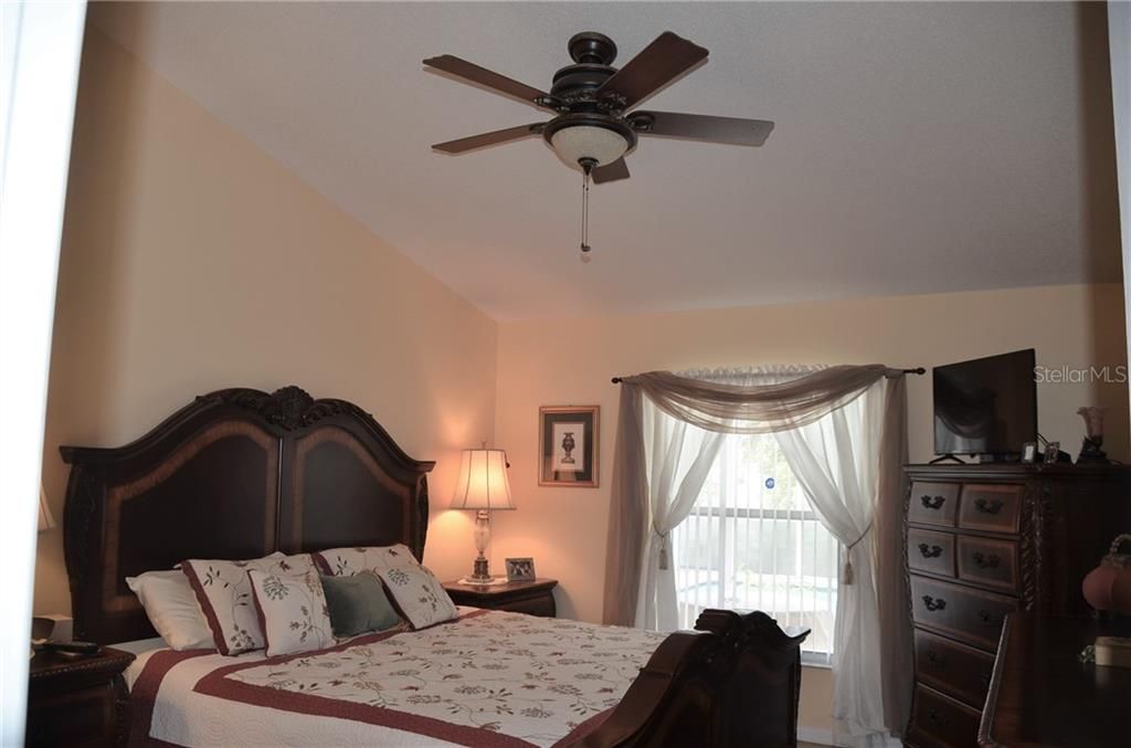 Owners Suite Bedroom Has Vaulted Ceiling And Ceiling Fan With Light.