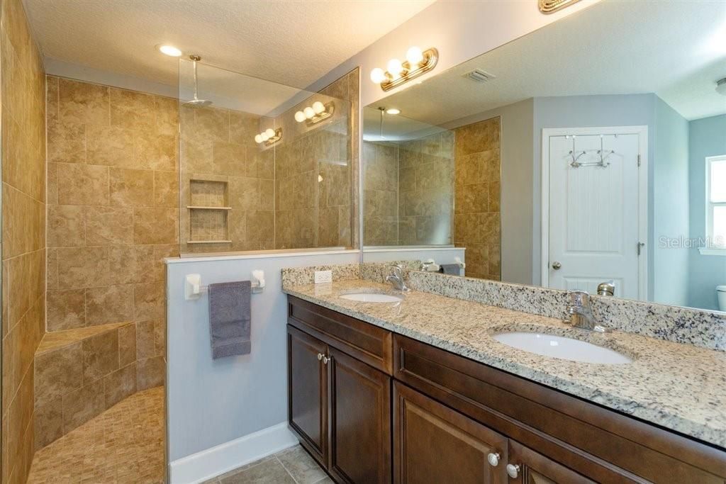 Large walk-in shower, double sinks and granite counter tops