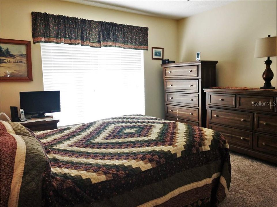 Spacious guest bedroom also has newer carpeting.