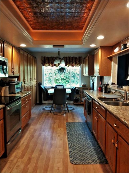Beautiful eat in kitchen features stainless appliances, granite countertops and Kraft Maid Oak cabinets.