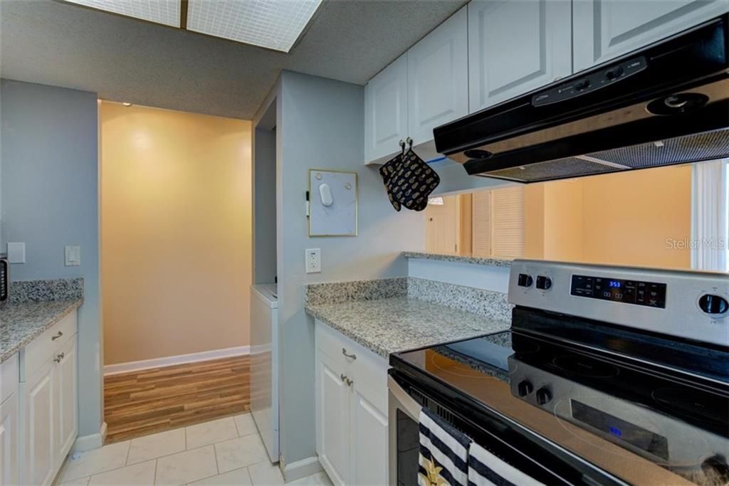Stainless steel appliances and granite counter tops in the large open kitchen