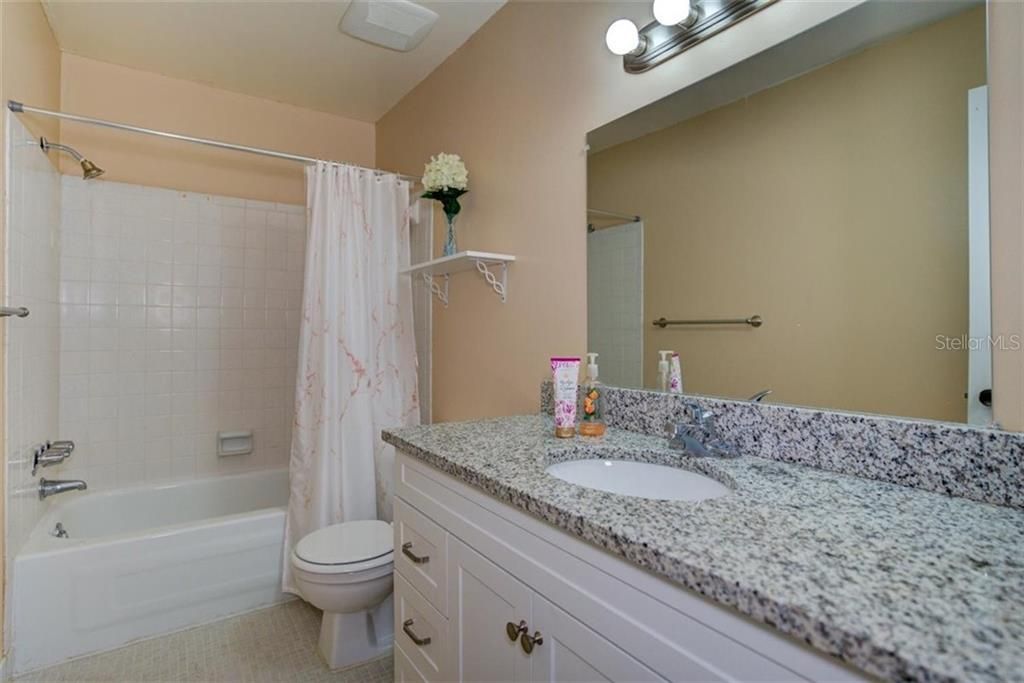 Second bathroom with large stand up shower as well as a soaking tub and stone counter tops