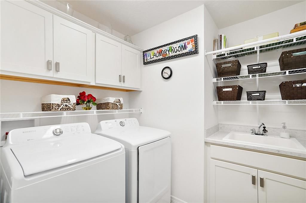 Inside laundry room with utility sink & extra cabinet space