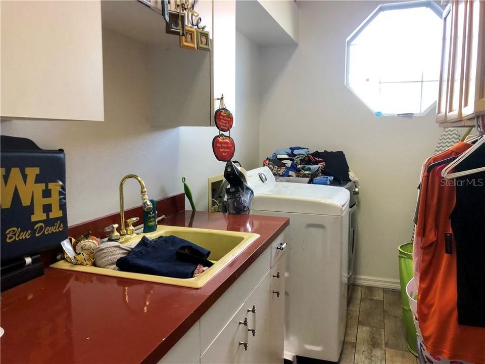 Laundry room w/ lots of cupboards and a sink