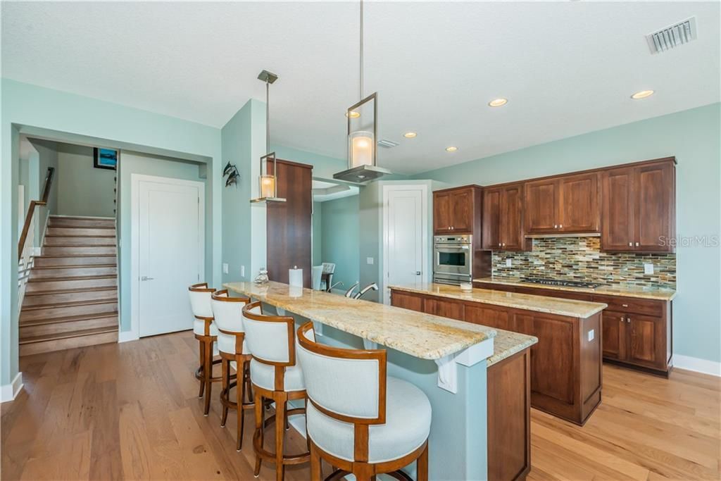 Gourmet kitchen with top of the line appliances, center island and breakfast bar.