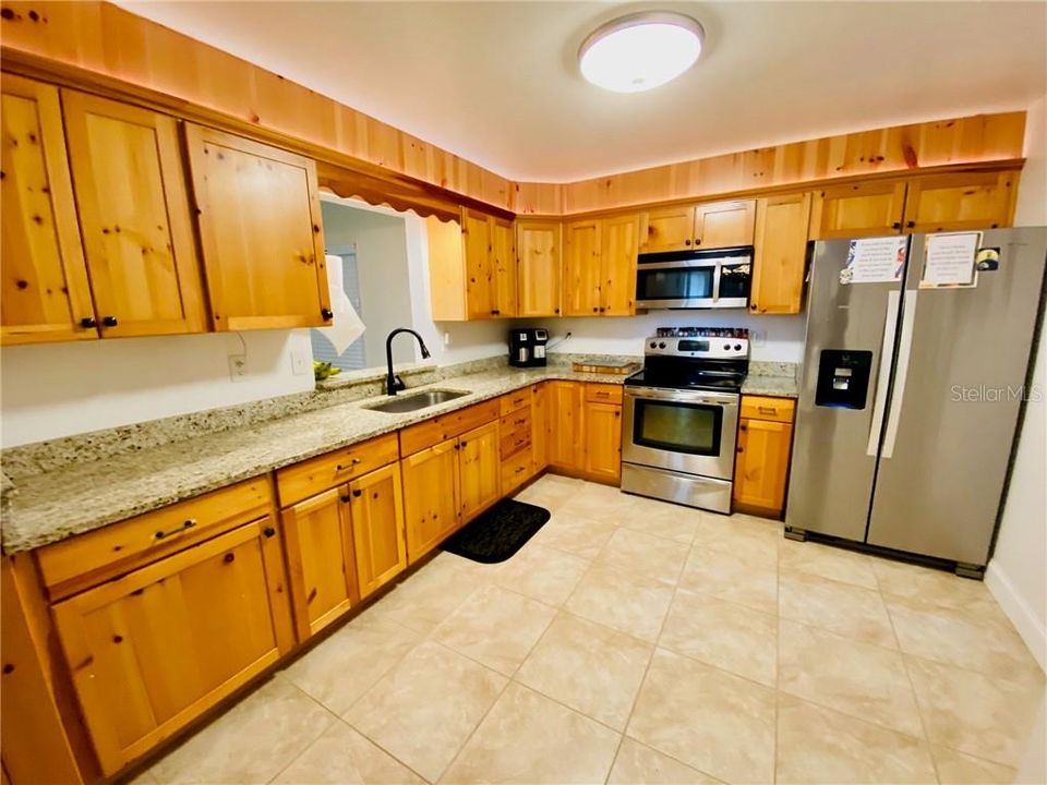 Kitchen with Wood Cabinetry, Granite Counter Tops and stainless type appliances