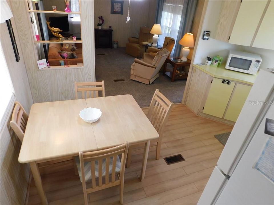 Eat-in kitchen has many updates including flooring and newer appliances.