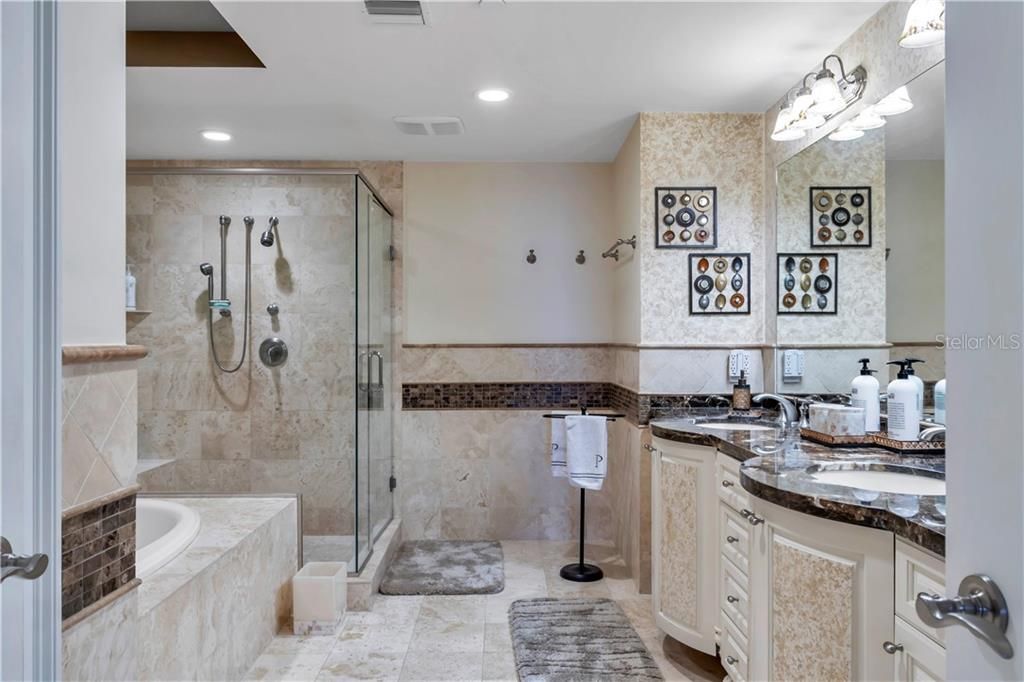 Large master bathroom with tub, shower and double sink, separate toilet