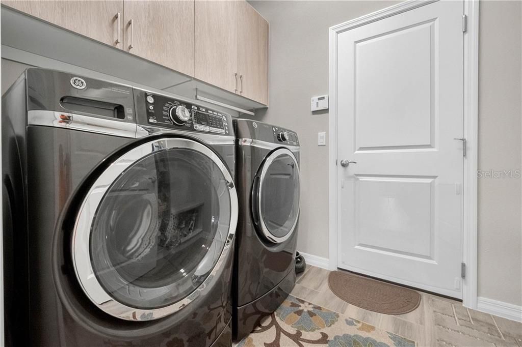 Your utility room features additional cabinetry.  Washer and dryer do not convey but negotiable