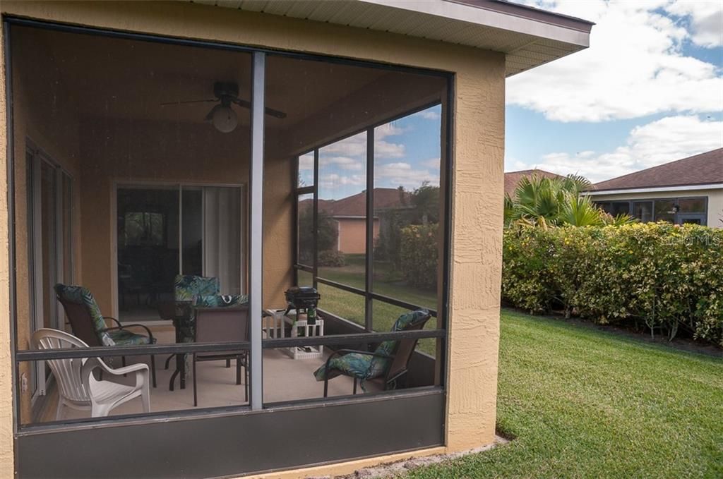 The extra thick hedge adds privacy to the covered and screened lanai.