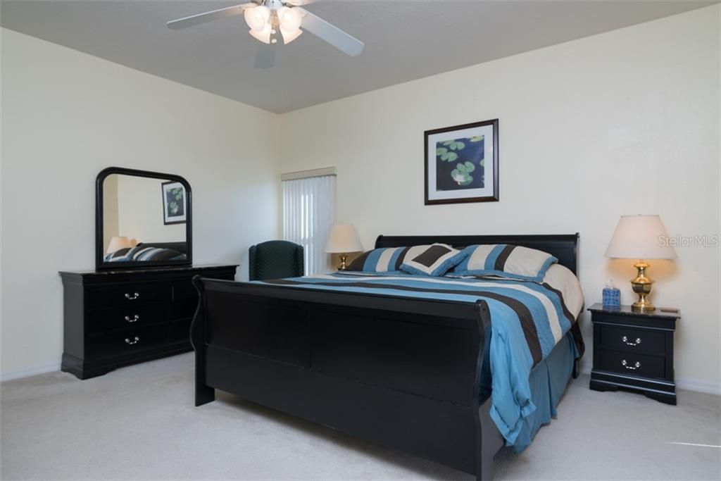 The large master bedroom has quality carpeting, ceiling fan with light and a large walk-in closet.