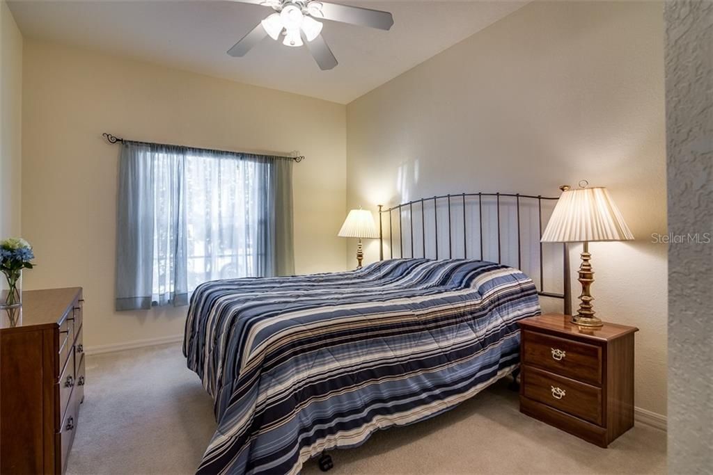 The guest bedroom features quality carpeting, ceiling fan with light and a large reach in closet.