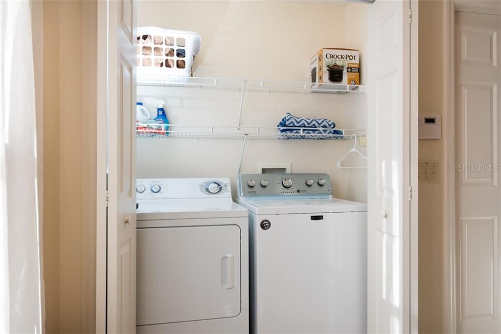 The laundry closet is located in the kitchen and features a new washer.
