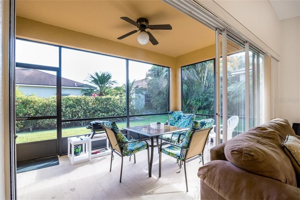 The covered and screen lanai has a ceiling fan with light.
