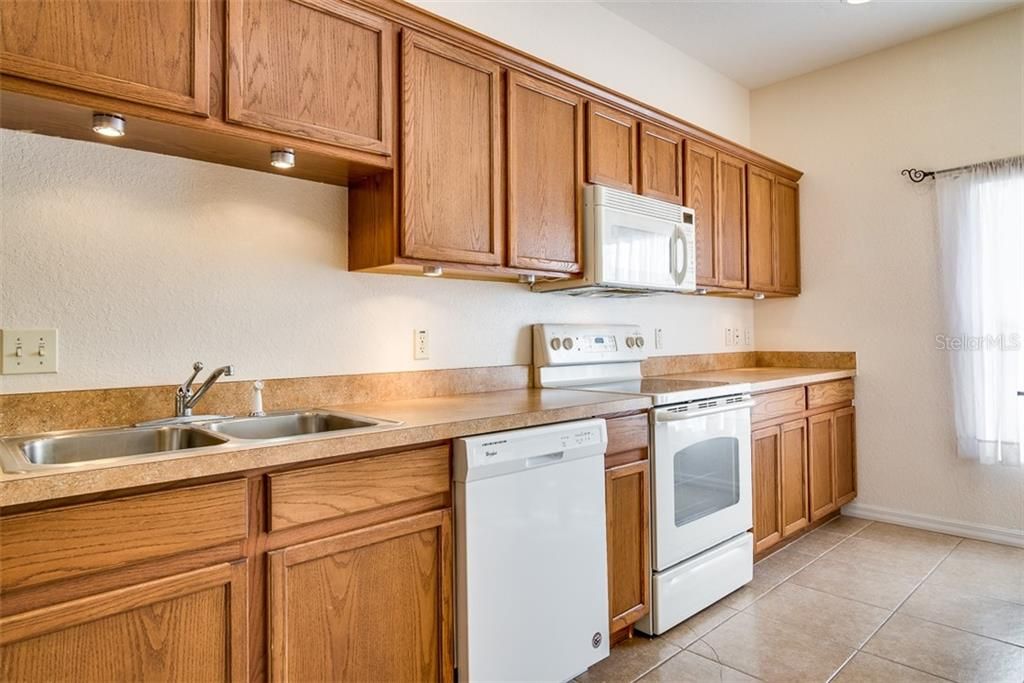 The kitchen features ample oak cabinetry with crown molding and lots of counter space.