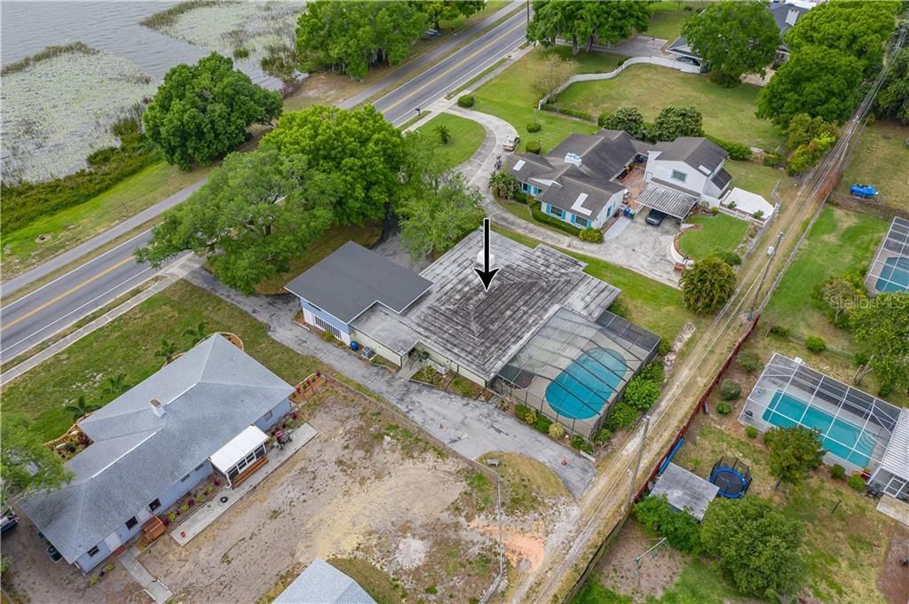 AERIAL VIEW OF HOUSE, POOL,  DRIVEWAY, ALLEY AND 100 LINEAR FEET LAKEFRONT AREA THAT IS INCLUDED WITH THE PROPERTY
