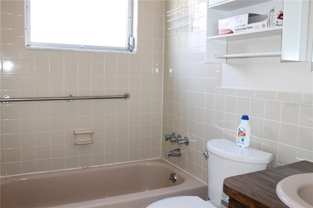 Bathroom with Tub and newer Toilet