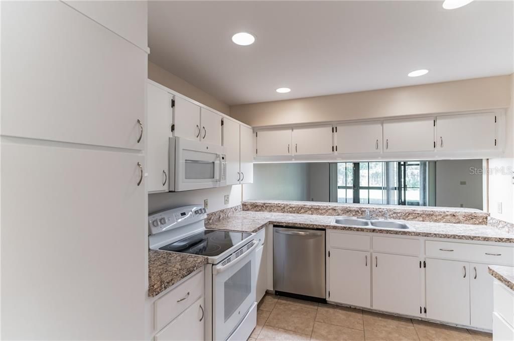 The kitchen features upgraded recessed lighting.