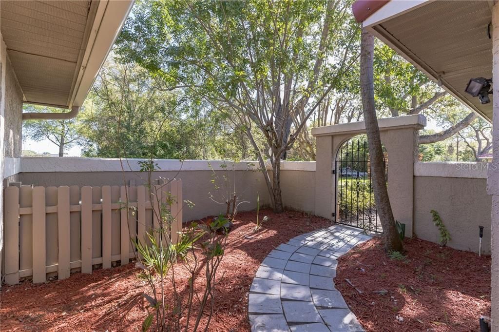 Privately gated courtyard with adequate planters to accommodate your favorite bed of flowers or personal herb garden.