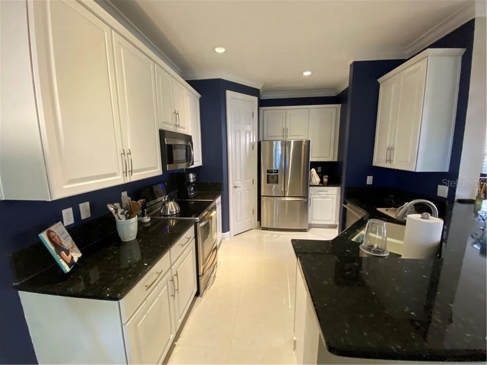 Kitchen from the family room.  Granite counters, high-n stainless appliances.