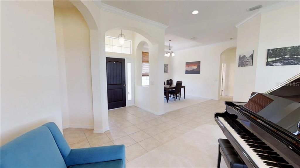 Entry showing living room and formal dining with furniture