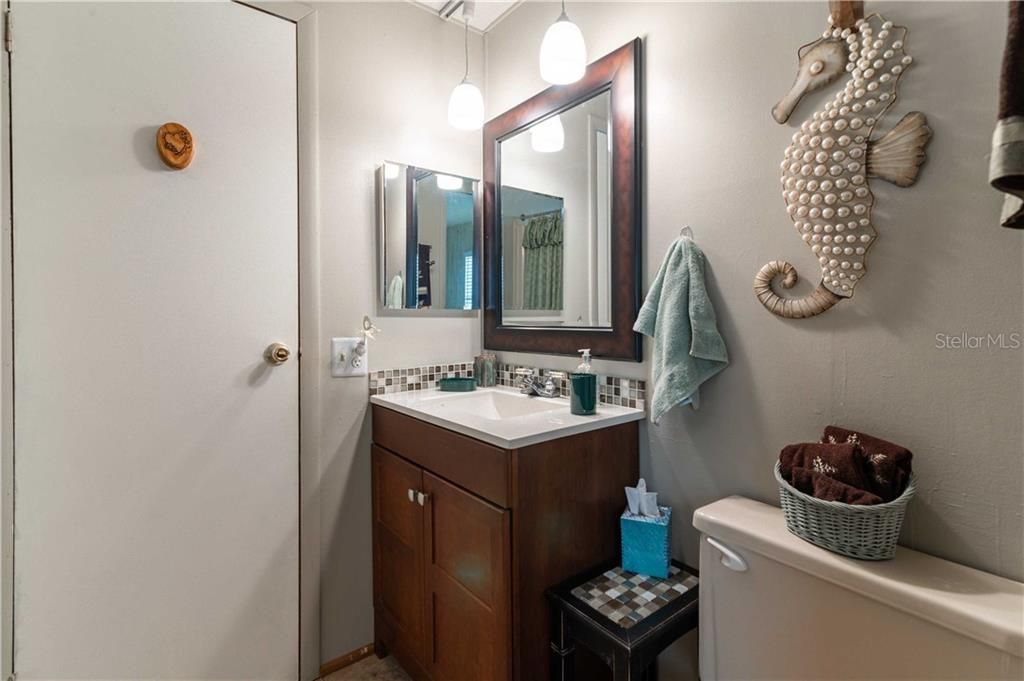Guest bathroom has updated vanity and fixtures.