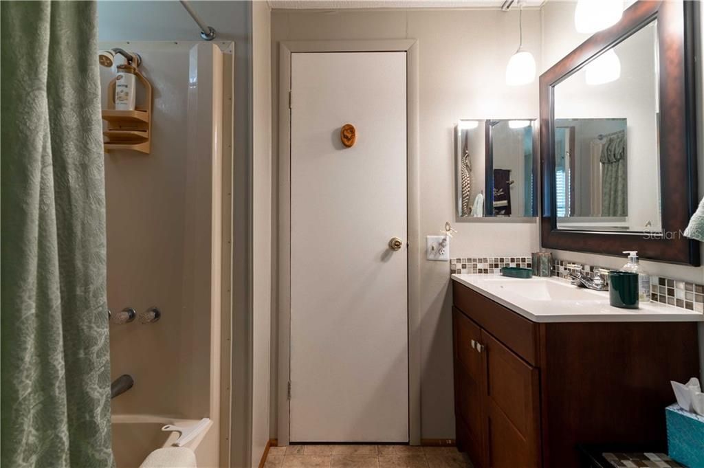 Guest bathroom has tub/shower combo.
