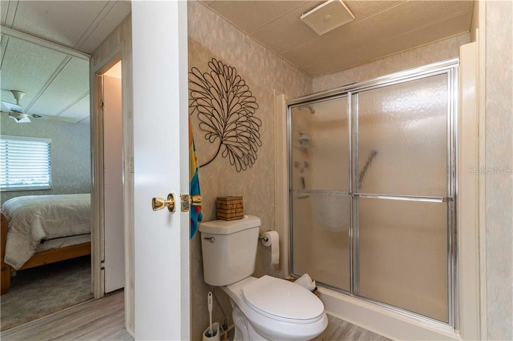 Master bathroom has step-in shower, updated high toilet, and flooring updates.