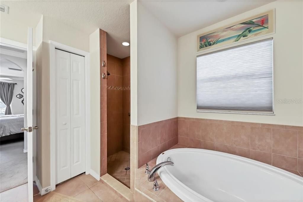 en suite soaking tub and walk in tiled shower