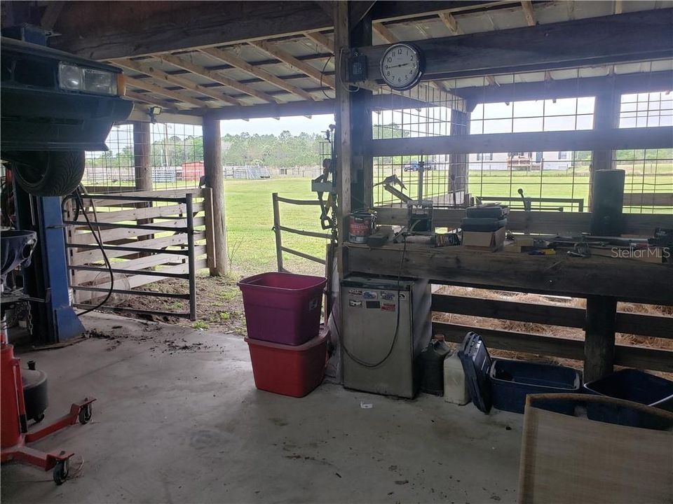 Stalls attached to workshop with a middle gate that could be a THIRD Horse Stall!