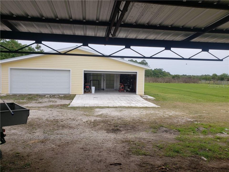 3 total double wide garage doors.  Left side opens completely up through to the other side, right side currently contains a full size paint booth so you can finish your cars off professionally.  Paint booth can be negotiated separately.