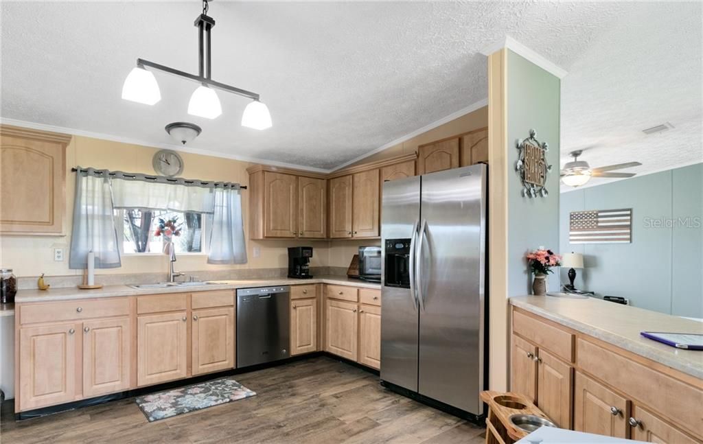 Expansive open kitchen w/ stainless appliances and new lighting throughout the house